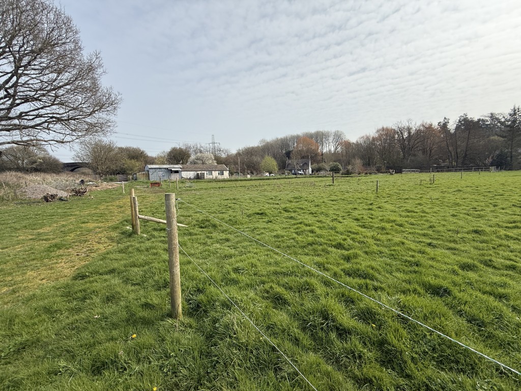 Lot: 144 - DETACHED COTTAGE WITH OUTBUILDING AND STABLES ON A SITE MEASURING OVER SIX ACRES - View from land towards outbuildings and cottage